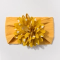 Detail of baby headband featuring yellow jacquard nylon and large white polka dot floral decoration - Mustard Yellow