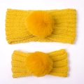 Detail of yellow knit parent-child headband set featuring soft faux fur balls for winter - Two-Piece Set / Yellow