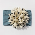 Close-up of baby nylon headband featuring a large cream flower with heart patterns - Navy Blue