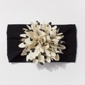 Close-up of baby nylon headband with large cream polka dot flower and black elastic band - Black