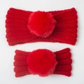 Close-up of mother and child red knitted headbands with fluffy faux fur pom-poms - Two-Piece Set / Red