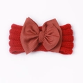 Close-up of baby knit headband with large ribbed bow in red and rust color tones - Red