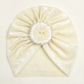 Close-up detail of cream white velvet baby donut hat with soft plush texture - Beige