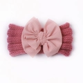 Detail of soft knitted baby headband featuring a large layered bow in dusty pink - Dusky Pink