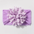 Detail of baby elastic headband featuring a large purple chiffon floral bow with polka dots - Purple