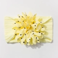 Detail of baby headband featuring yellow jacquard nylon and a large black polka dot floral bow - Beige
