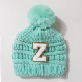 Mint green knit baby hat with a large faux fur pompom and a gold-edged Z letter patch - Mint Green