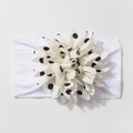 Dettaglio della fascia per neonati con trama a maglia e decorazione floreale a pois neri - Bianco