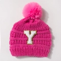 Close-up of knit baby hat with pink faux fur pom-pom and embroidered letter Y patch - Rose Red