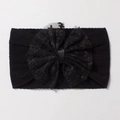 Détail d'un bandeau bébé en nylon jacquard noir avec un grand nœud en dentelle et tissu côtelé - Noir