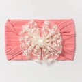Détail d'un bandeau rose pour bébé avec un nœud en dentelle blanche brodée délicat - Vieux Rose