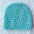Close-up of thick knit mint blue baby winter hat with textured crochet stitch pattern - Mint Green