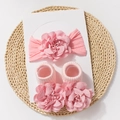 Baby pink headband and socks set with elegant layered fabric flowers on a woven mat - Pink