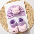 Detail of baby soft knit hat and socks set featuring cute 3D plush pink pig decorations - Purple