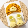 Detailed view of yellow baby turban hat and ribbed socks with cute plush chick face accents - Earthy Yellow