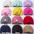 Detailed grid showing twelve colors of baby knit beanies with bows and soft pom-poms - 12 Colors Mixed