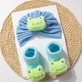 Detail showing a blue baby turban and ribbed socks with cute 3D green frog dolls - Blue