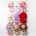 Flat lay detail of baby knit hat and socks set featuring large layered 3D flowers in 9 colors - Contact For Paper Card