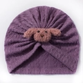 Detailed close-up of a purple knitted baby turban hat with a plush pink puppy decoration - Deep Purple