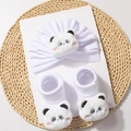 Detail view of baby knitted hat and socks set featuring cute plush panda faces in white - White