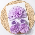 Macro view of purple knitted baby hat and socks with large 3D handmade floral detail - Purple