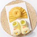 Detail of soft yellow baby turban hat and 3D cartoon duck socks set on woven mat - Khaki/Earth Yellow