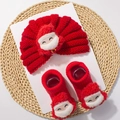 Close-up of red knitted baby hat and socks with cute Santa Claus 3D details - Red 3D Applique Style B