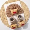Detail of baby knitted winter set featuring warm hat and socks with cute reindeer decor - Camel Reindeer Style G