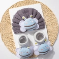 Detail of knitted baby turban hat and striped socks with blue plush insect decors - Gray