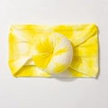 Detail of baby nylon headband featuring a large yellow and white tie-dye donut flower ball - Bright Yellow