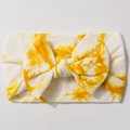 Detail showing soft nylon tie-dye fabric and large bow on the yellow baby headband - Earthy Yellow