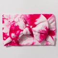 Close-up of soft nylon tie-dye bow headband with vibrant rose red and white patterns - Rose Red