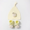 Detailed view of yellow modal baby hat and socks set with 3D teddy bear design - Beige