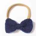 Close-up of a navy blue knitted bow baby headband with high-elastic nylon band - Navy Blue