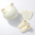 Flat lay detail of newborn bear ear hat, anti-scratch mittens, and soft knit booties - Beige