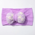 Close-up of purple knit baby headband with embroidered padded bow and floral details - Purple