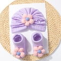 Detail of soft purple knit baby turban hat and matching socks with 3D floral accents - Purple