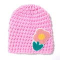 Close-up of bright pink knitted baby hat featuring soft flower embroidery detail - Pink