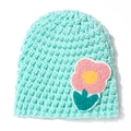 Close-up of mint green knitted baby hat featuring 3D pink flower embroidery detail - Mint Green