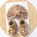 Detail of baby turban hat and socks set with 3D floral accents in warm beige cotton - Coffee