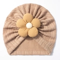 Close-up of cable knit baby turban hat with a large decorative corduroy flower - Light Coffee