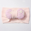 Dettaglio fascia per neonati in tessuto jacquard elasticizzato e fiocco ricamato - Rosa Chiaro