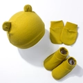 Detail view of mustard yellow knit baby hat with bear ears, scratch mittens and soft booties - Olive Green