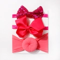 Detailed view of three-piece baby headband set with sequins, ribbed bows and soft fabric knot - Rose Red