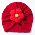 Close-up of baby knit hat showing arrow pattern texture and 3D floral decoration - Red