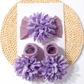 Detail view of purple baby headband and socks set featuring large floral fabric accents - Taro Purple