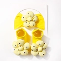 Detail of yellow baby headband and socks set with 3D floral accents on white card - Bright Yellow