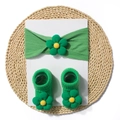 Detailed shot of green baby headband and socks set with 3D floral accents on white card - Green