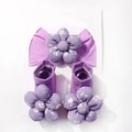 Detail view of purple baby headband and socks set with 3D floral accents on display card - Purple