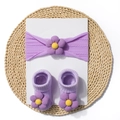 Macro view of purple knit baby headband and socks set with soft 3D floral details - Purple